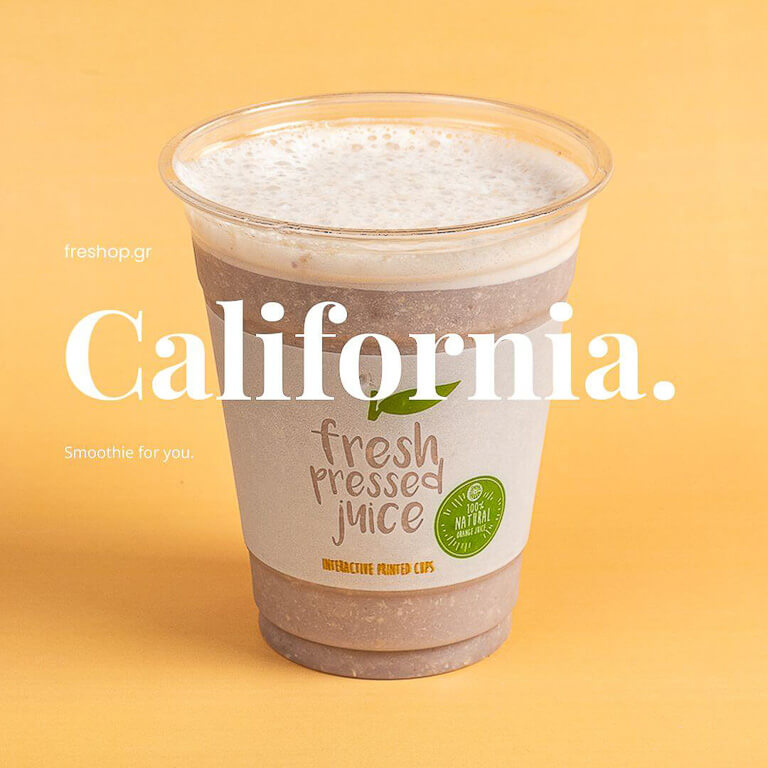 transparent glass with California smoothie on a yellow background