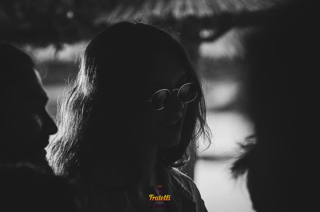 dark photo with a girl wearing black sunglasses and a boy next to her