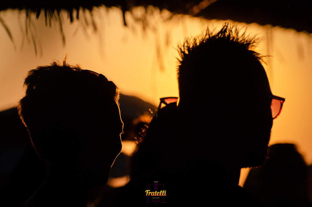 dark photo with people in a beach bar