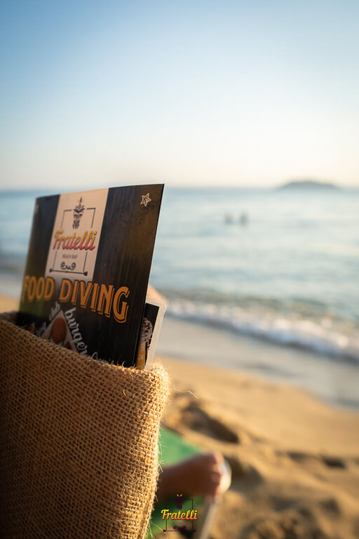 the straw case that has the menu of the Fratelli Beach Bar