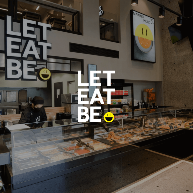 Let Eat Be restaurant with staff working and the Logo.