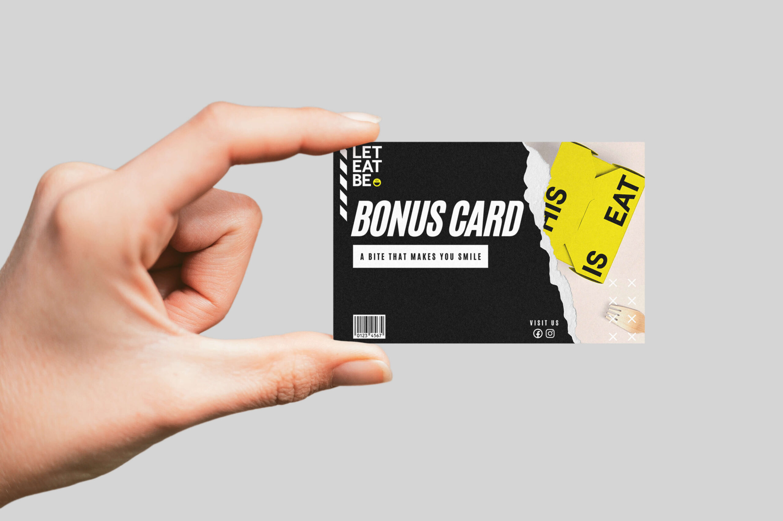 A hand presenting Bonus Cards Let Eat Be